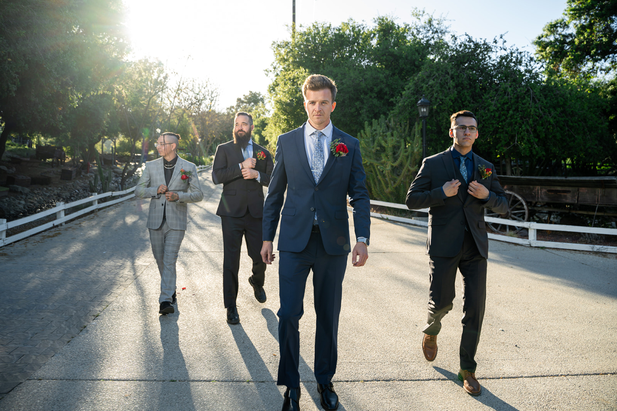 Groomsmen walking toward the camera with confident, swagger-filled expressions.