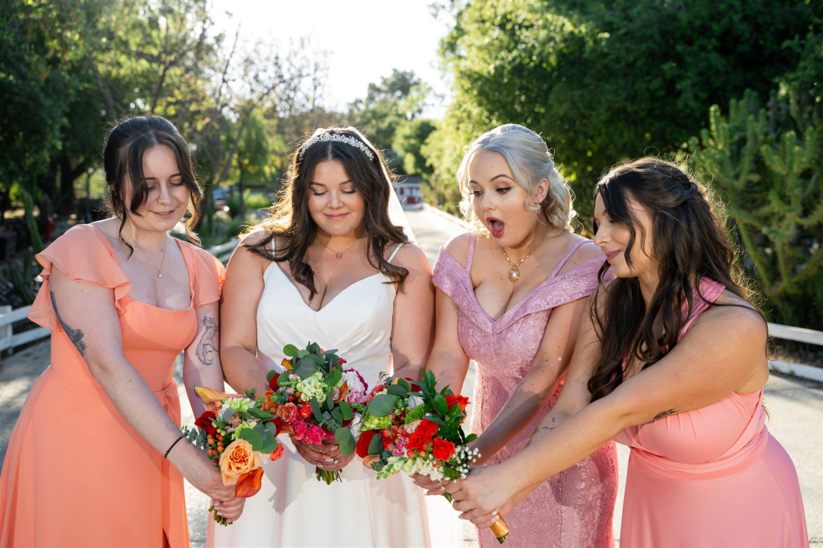 Bridesmaids lifting the bride for a playful, celebratory photo.